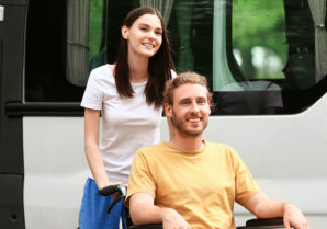 adult man in wheelchair with his aide