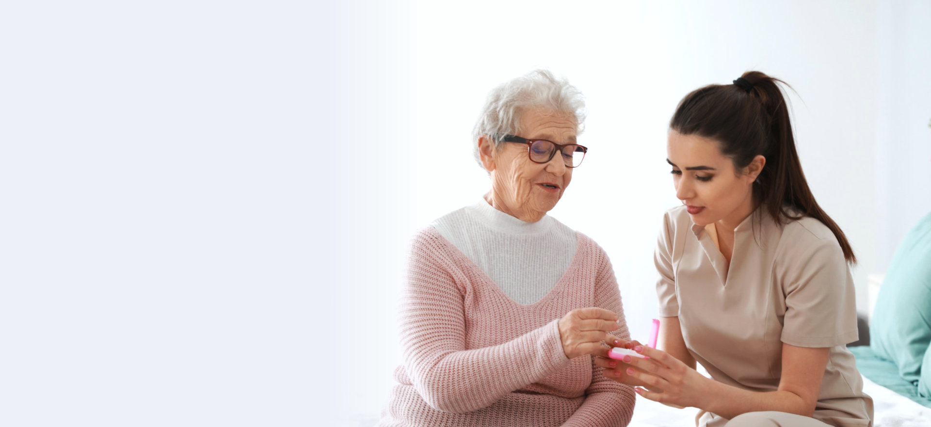 caregiver giving medicine to the senior woman