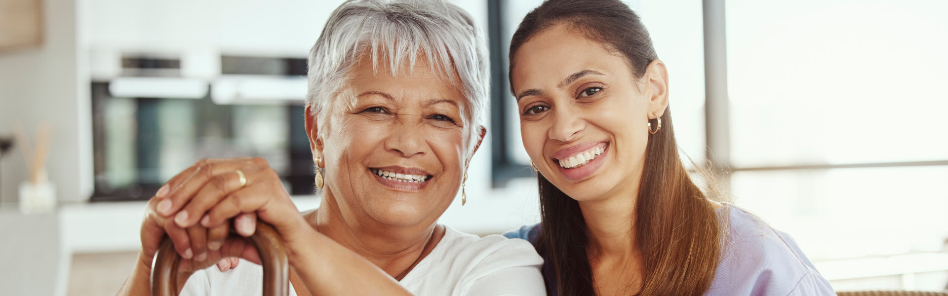 caregiver and elderly woman smiling