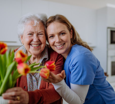 elderly and caregiver in a kitchen