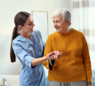 senior assisted by her aide