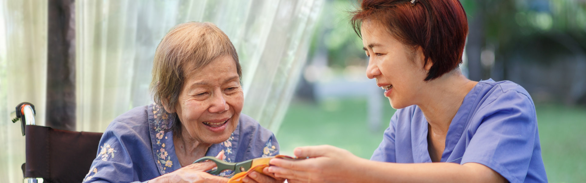 aide and senior woman smiling